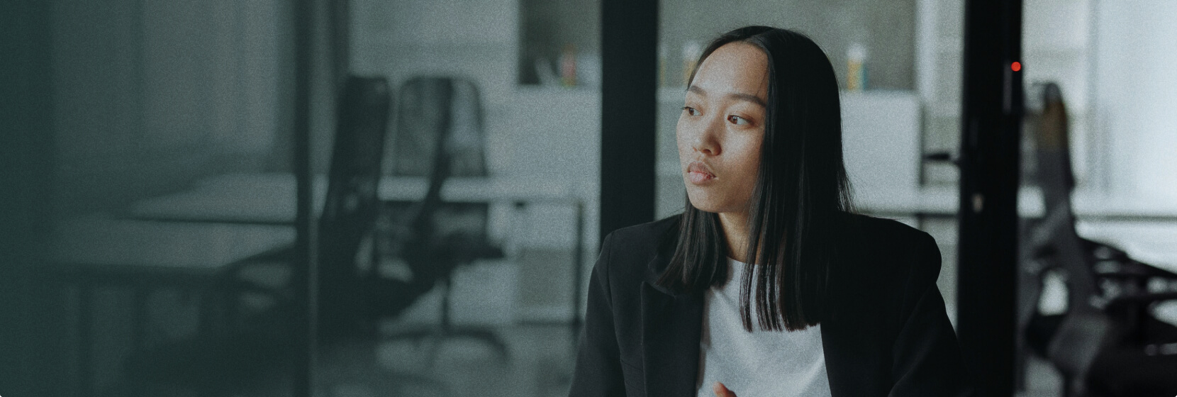 Professional woman at Odextra office, considering managed web hosting strategies